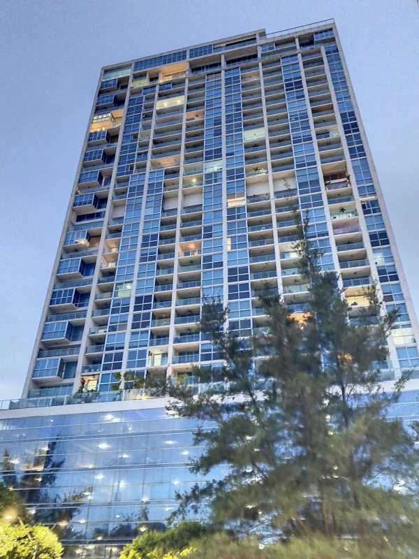 Fully furnished bedroom with large windows and ocean views in PH H2O Panama City