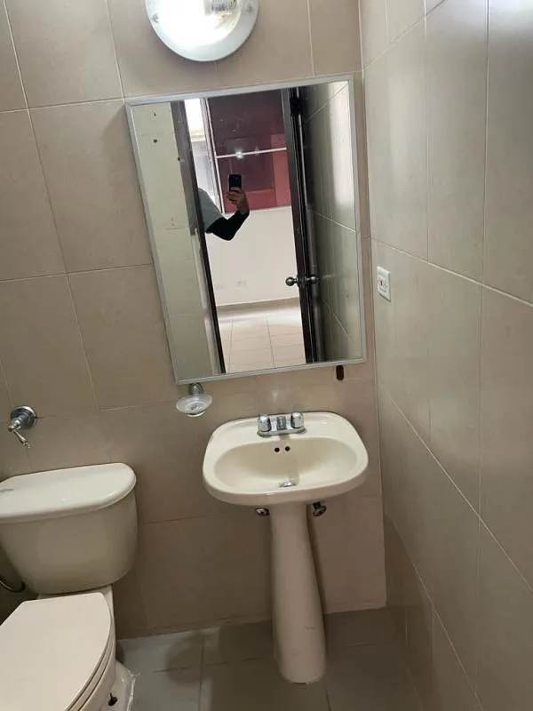 Compact bathroom with beige tiles in Mallorca Park Garden II Panama City apartment