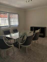 Dining area with large windows and security bars in rental house Villa Mercedes David Panama