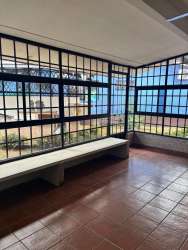 Contemporary suburban house with driveway, carport, security bars, garden area in Villa Mercedes David Panama