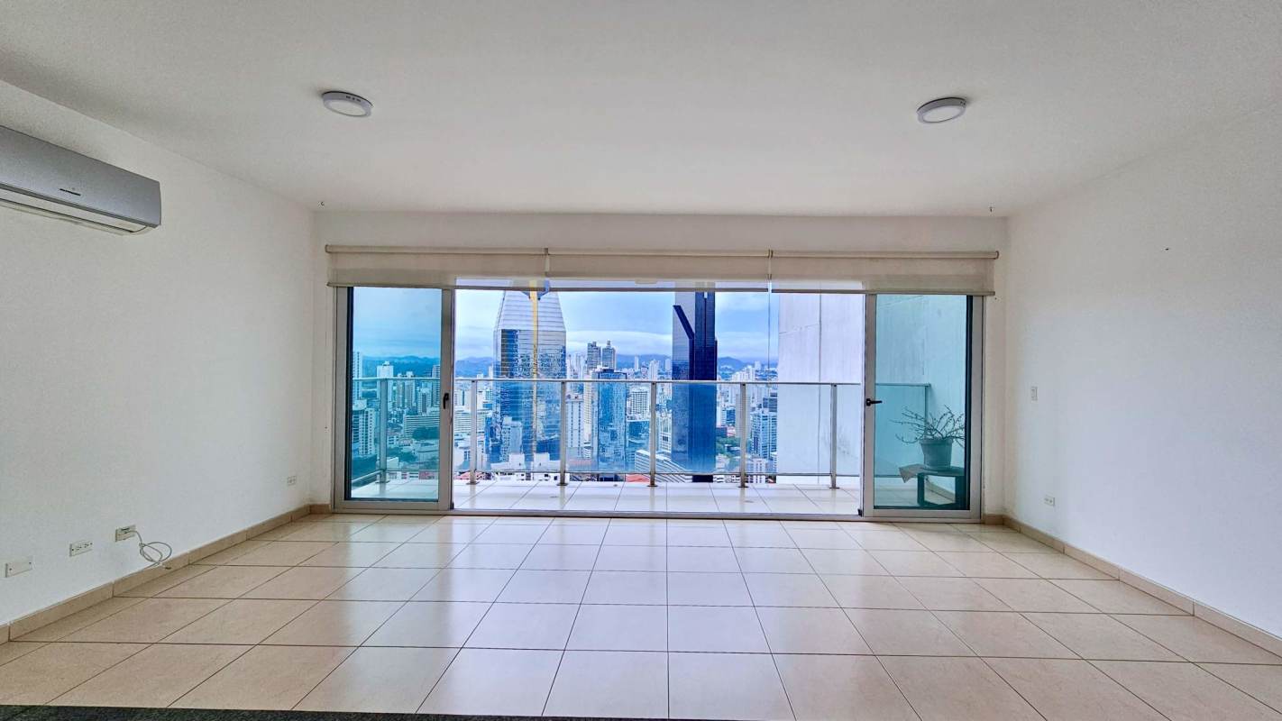 Stylish infinity pool area with glass railing overlooking ocean and Panama skyline at PH Waters