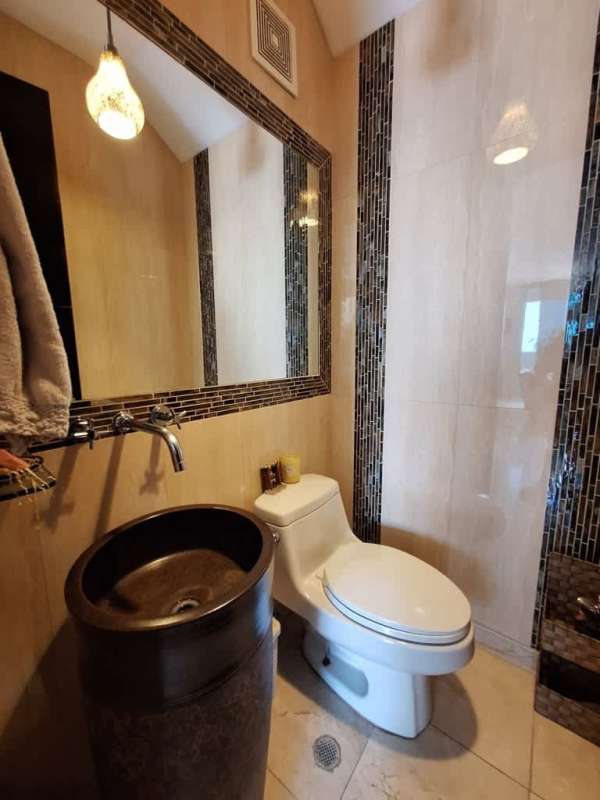 Second bedroom with workspace, large window, and city view PH Costa Pacifica