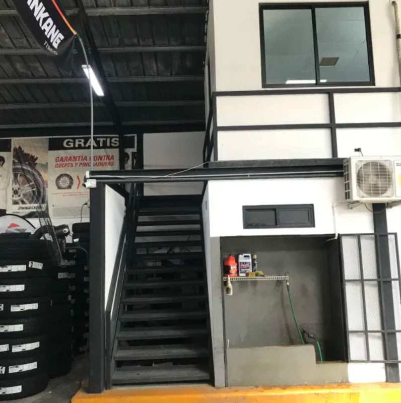Industrial warehouse interior with mezzanine, workshop and stacked tires in Parque Lefevre Panama