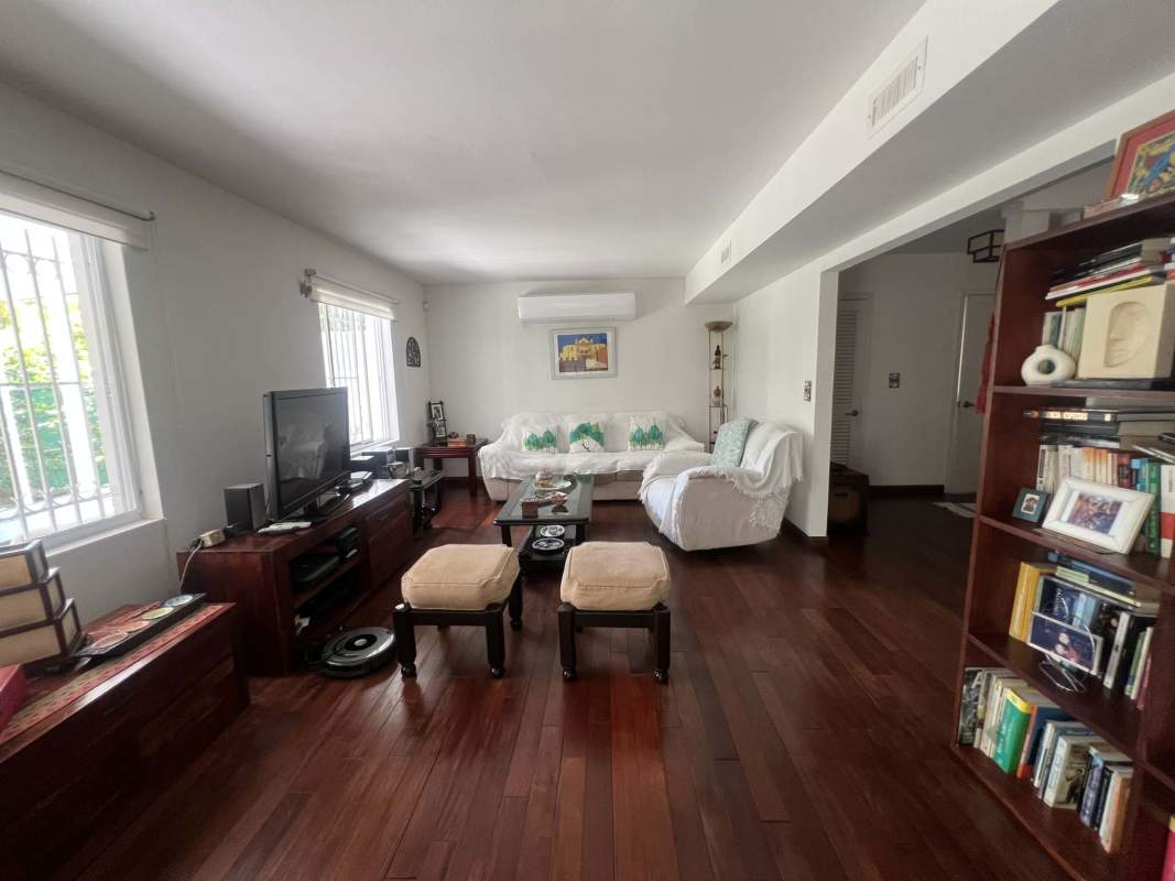 Kitchen with wooden cabinets, gas stove, and large window in rental house Clayton Panama