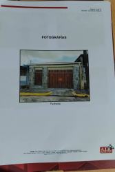 Exterior house with stone facade, garage door, secure pedestrian entry at Praderas de San Isidro Puerto Pilón Colón Panama