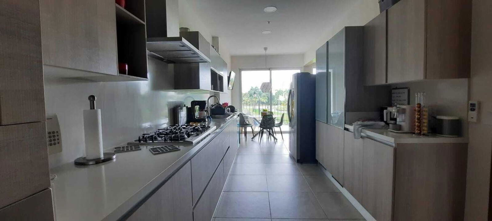 Luxury apartment dining area with floor-to-ceiling glass and golf course views in The Reserve Santa María Panama