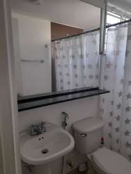 Full bathroom with white fixtures, large mirror, bathtub curtain at PH Pacific Hills rental Panama