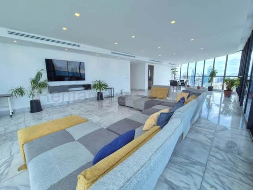 Open plan lounge dining area floor-to-ceiling windows, city skyline at PH Marina Bay Tower Panama