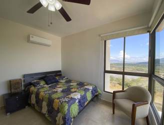 Living room with sectional sofa, ceiling fan, sliding doors to oceanfront balcony at PH Biltmore