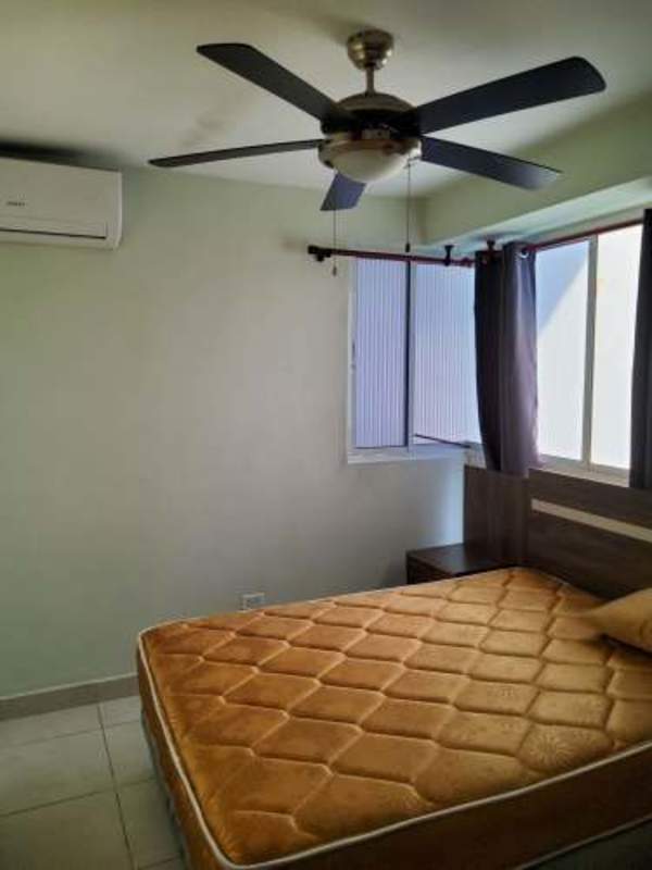 Living and dining area with blue sofa, glass table, and city view balcony PH El Mare 500 Edinson Park