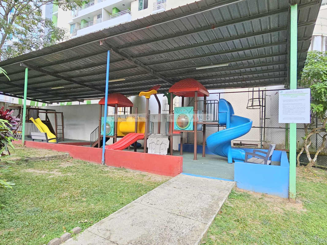 Colorful children's playground covered area in PH Green Park with slides and swings Condado del Rey Panama