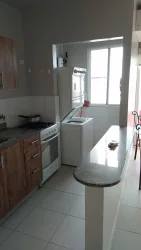 Compact kitchen illuminated with natural light at PH Vista Azul Playa Dorada