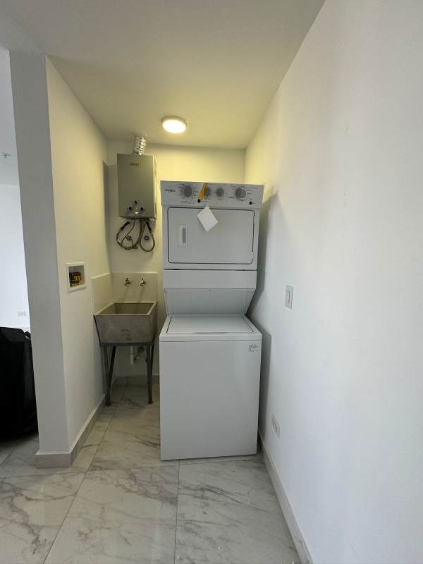 Laundry room with washer dryer hookup, marble tile and sink in PH The Gray Panama City