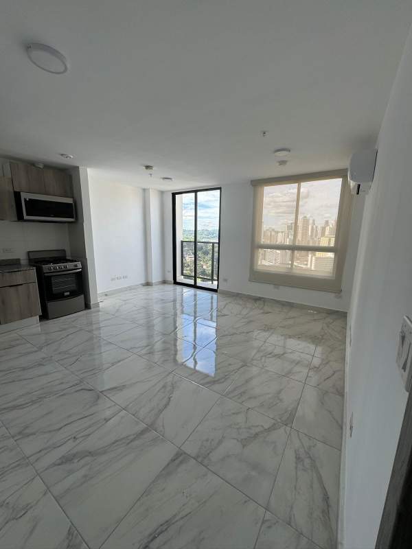 Modern kitchen and living area with marble tile flooring and large windows PH The Gray Panama