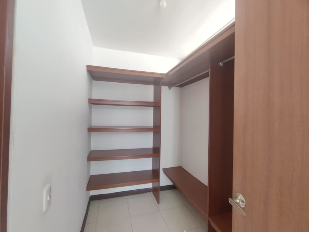 Minimalist dining area with shelving, open doorway, white tile floor Altavista Tower El Bosque Panama