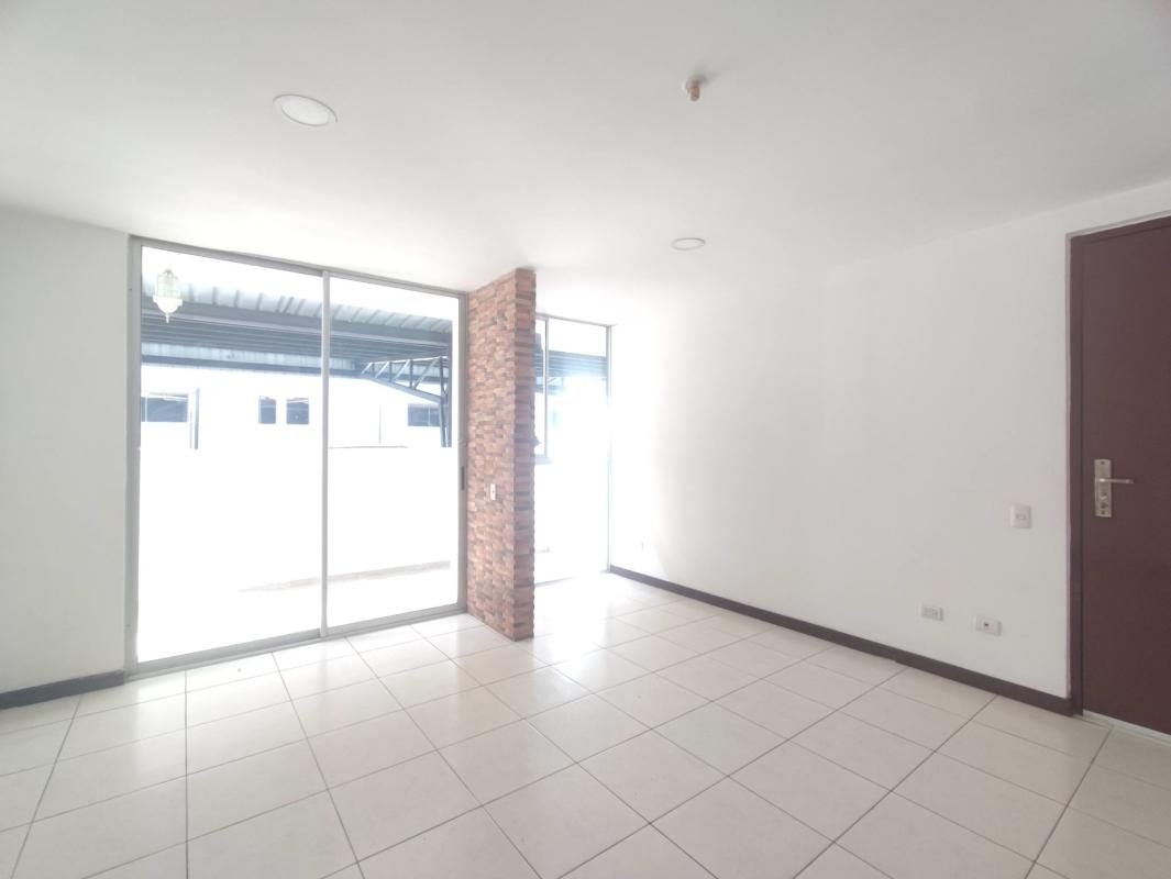 Bright living room with sliding glass door, brick column PH Altavista Tower El Bosque Panama