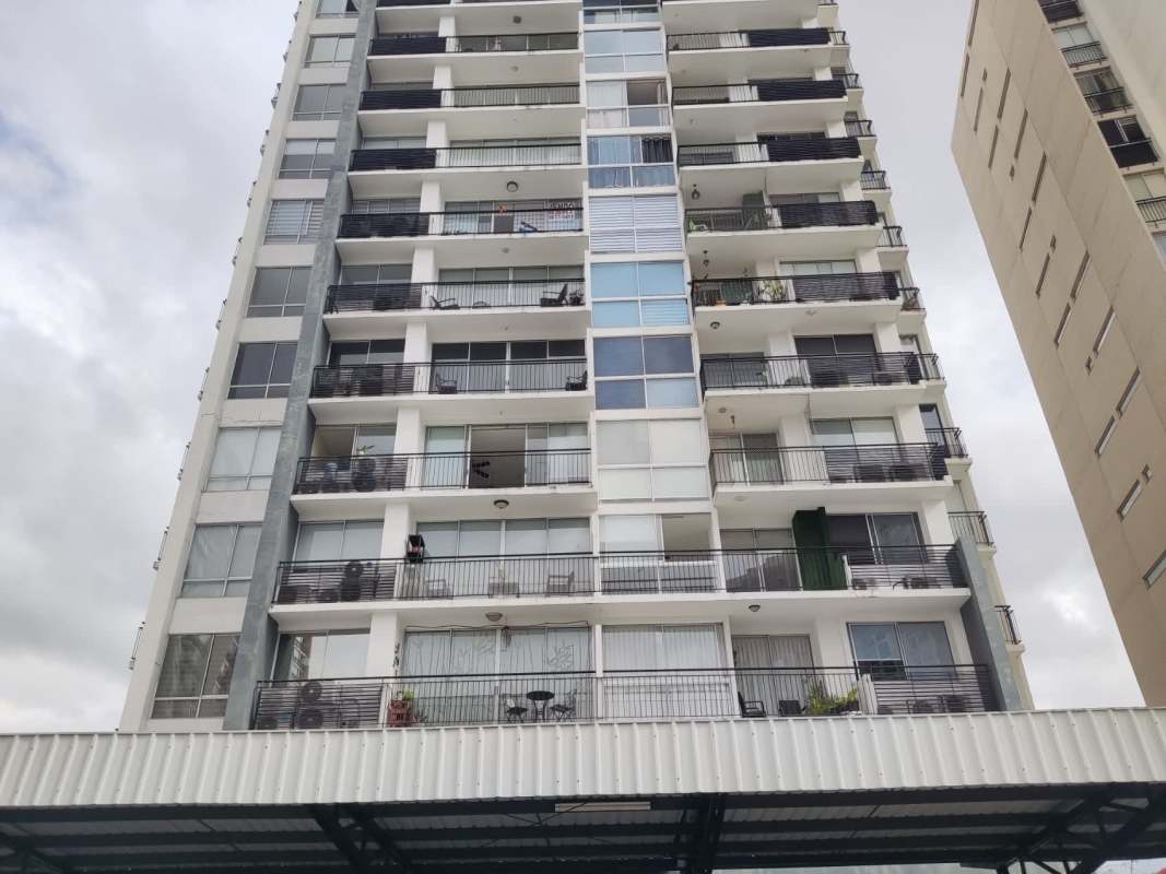 Modern multi-story apartment building with balconies and parking in Altavista Tower Panama City