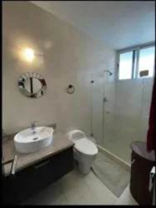 Modern bathroom with vessel sink, glass shower and designer fixtures at Pearl at the Sea