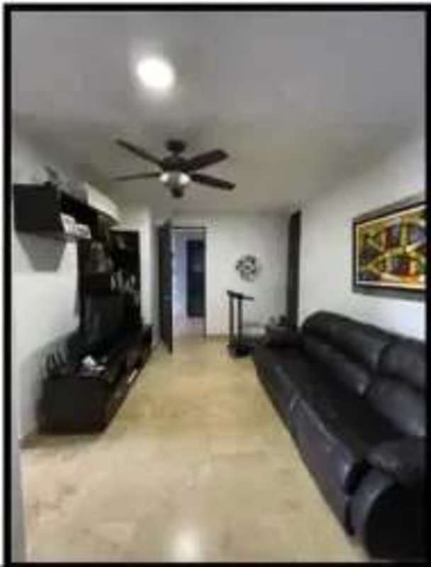 Modern spacious lounge with black leather sectional and entertainment center at Pearl at the Sea Panama