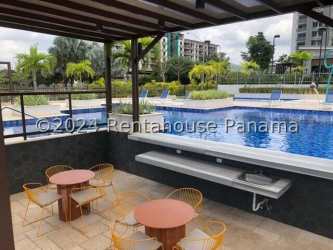 Swimming pool surrounded by lounge area and tropical landscaping PH Woodlands Panama Pacifico