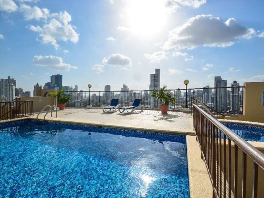 Kitchen with appliances, granite counters, and cabinets in PH Via Porras Panama City apartment