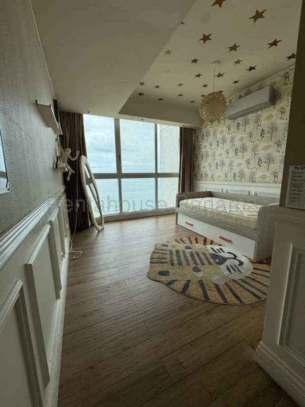 Kids bedroom with ocean views, large windows, playful decor in Punta Pacifica Panama