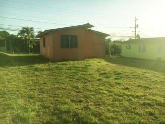 Peach-colored single-story house with large front yard in Arraijan Panama