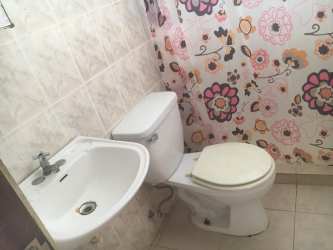 Teal accent wall with kitchen opening and overhead cabinets in Villas de La Alameda home Arraijan