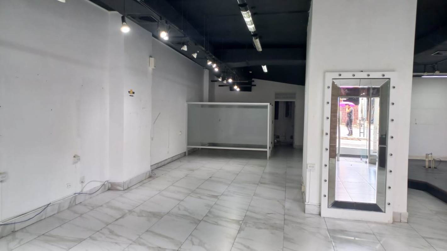Open modern commercial space with marble tiles and track lights for lease in Panama City