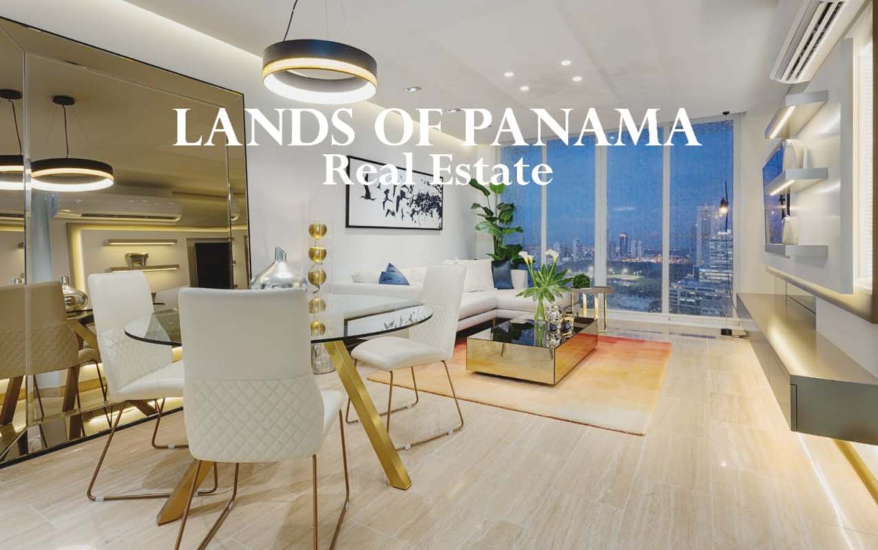 Dining area with glass table and white chairs in furnished apartment PH The Regent Costa del Este Panama