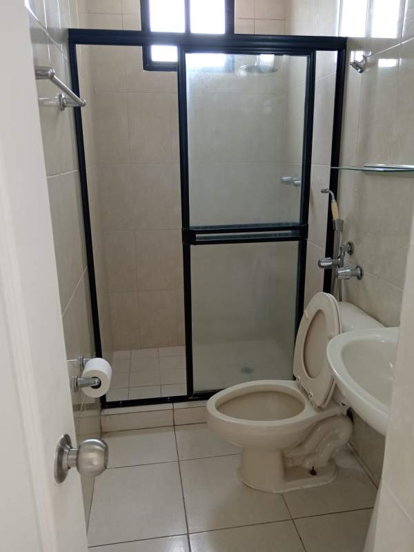 Modern bathroom with tile walls, glass shower, small window PH La Loma Park Hato Pintado Panama
