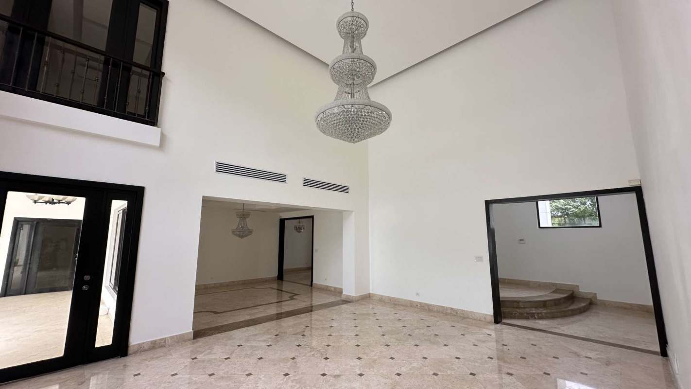 Luxury villa outdoor area with swimming pool palm trees privacy wall Costa del Este Panama