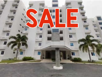 Multi-story white beachfront building with balconies Coral Reef Tower 5 Playa Blanca Panama