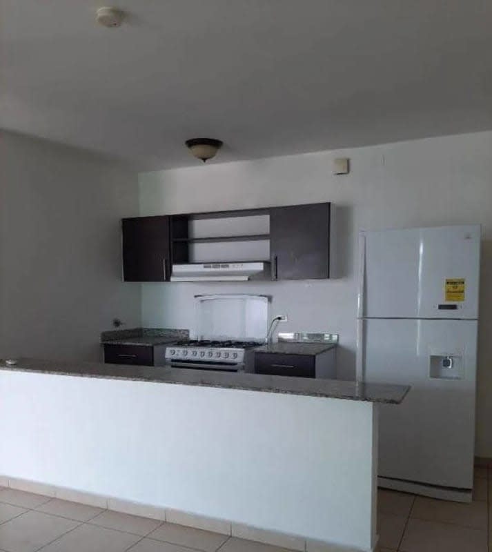Modern kitchen with white goods, granite countertops in PH El Cangrejo Tower Panama