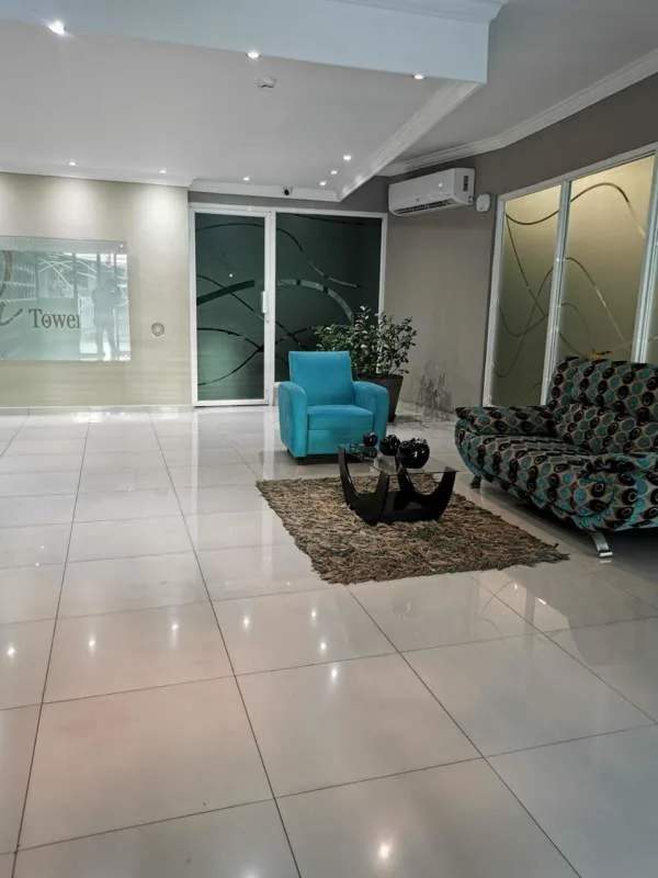 Elegant lobby with sofas and reception seating at PH El Cangrejo Tower Panama