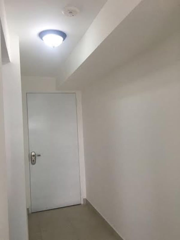 Simple hallway with white door, ceiling light, and tile flooring in PH Edison Park