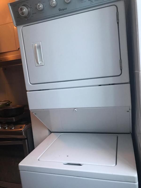 Stacked Whirlpool washer and dryer in apartment laundry area PH Edison Park Panama