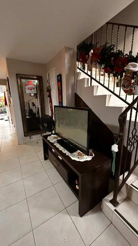 Spacious outdoor swimming pool with lounge chairs and palms in Dorado Lakes Condado del Rey