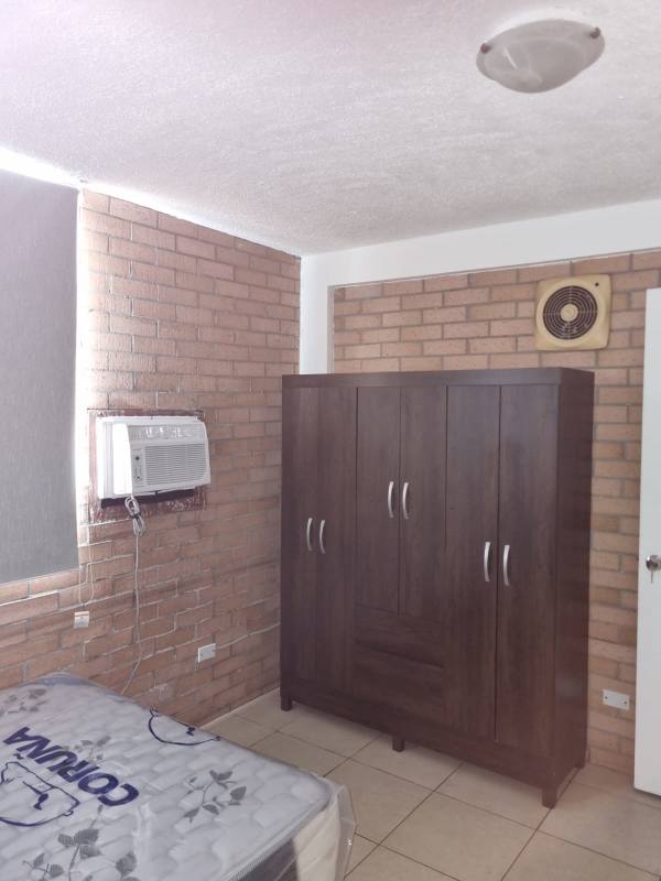 Bedroom with AC, brick wall, blinds and wardrobe in Multiplaza zone Panama