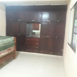 Bedroom with large dark wood wardrobe and tiled floor for rent Los Santos Panama