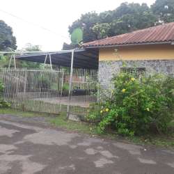 Small bathroom blue tile walls toilet and sink in house for rent El Ejido Los Santos Panama