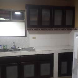 Kitchen with upper cabinets, double sink, tile counters in house for rent Los Santos Panama