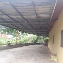 Covered parking area with metal roof attached to house Los Santos Panama