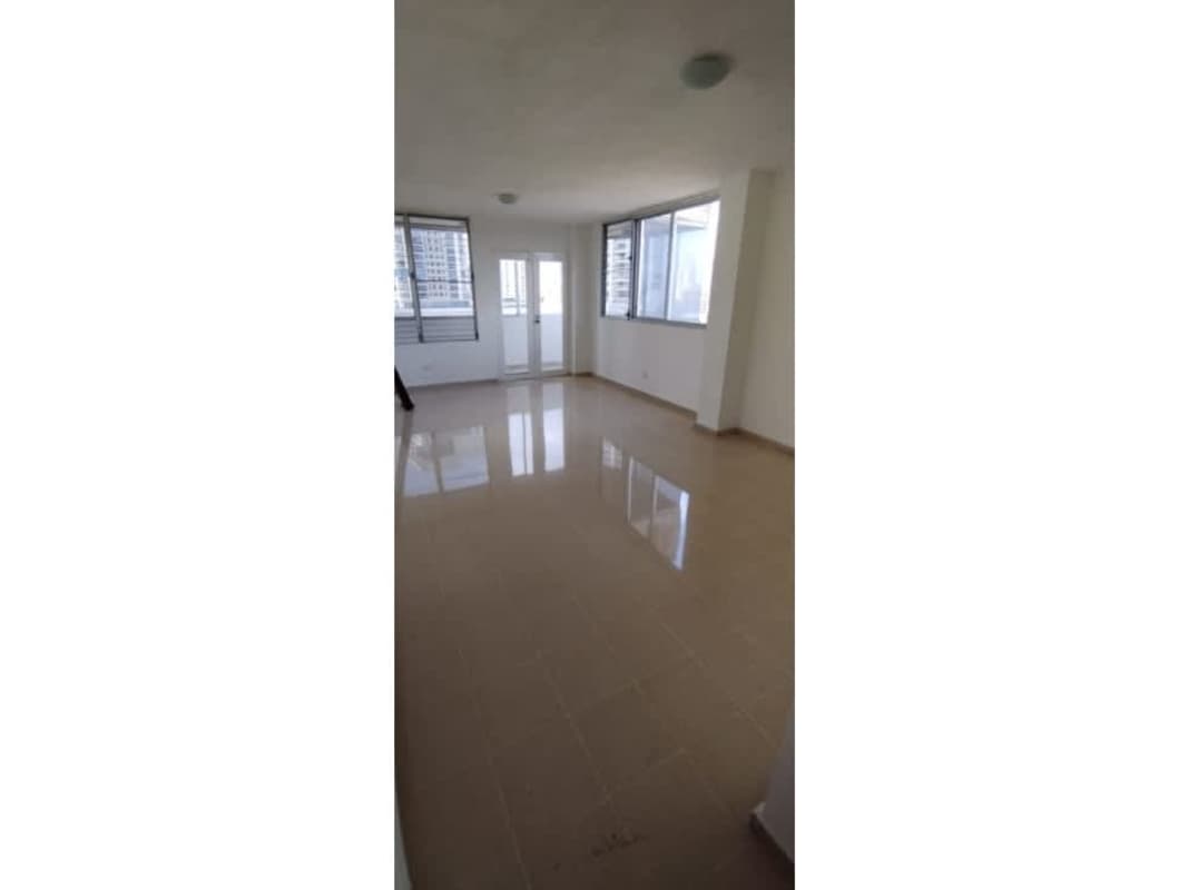 Open living-dining space with large windows and balcony access PH Altos del Golf Panama City