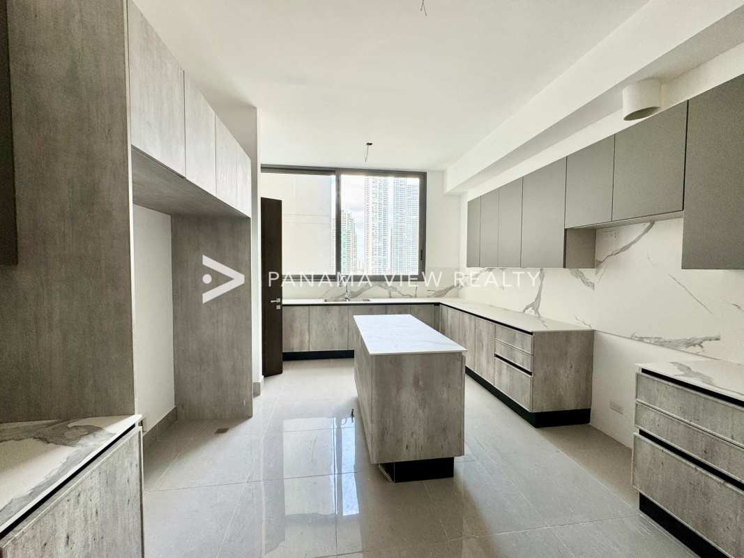 Kitchen with marble backsplash, center island, gray cabinetry at Sea Point in Panama City