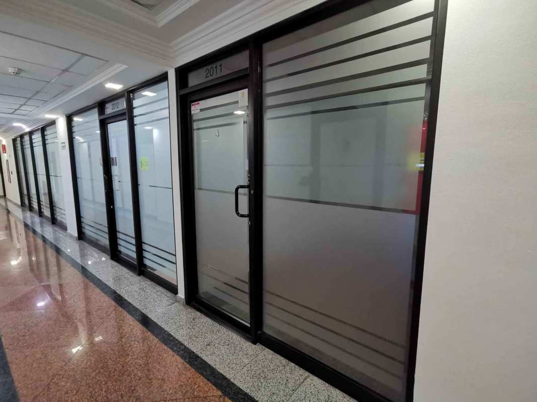 Interior commercial office corridor with glass doors and partitions Century Tower Panama City