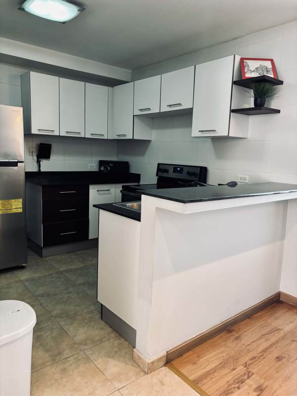 Spacious walk-in closet with built-in shelves and drawers in loft apartment PH Bayfront