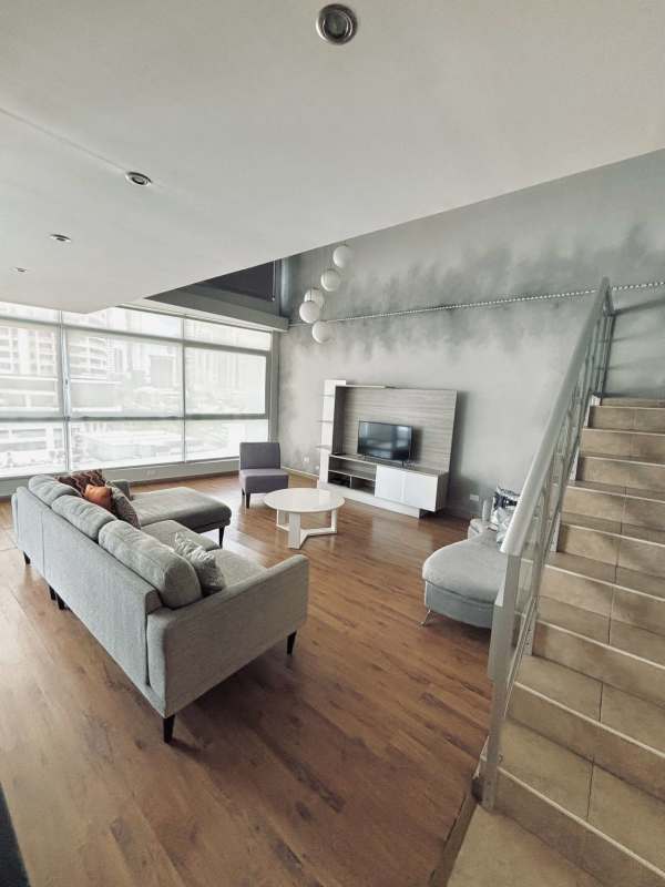 Open plan kitchen with granite countertops and stainless appliances in PH Bayfront loft