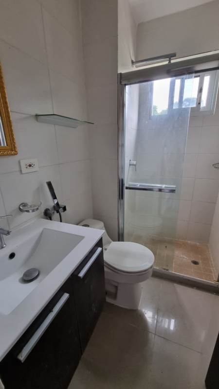 Contemporary bathroom with glass shower enclosure, mirror, and sink in Altamira Gardens Panama City