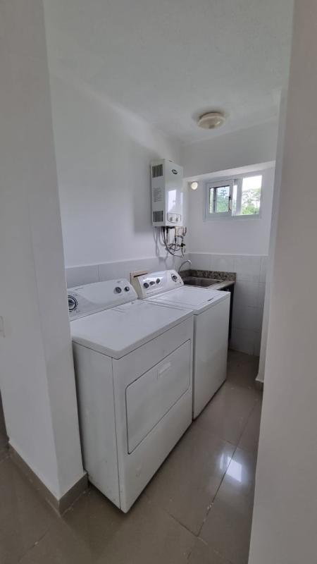 Laundry room with washer, dryer, utility sink and window in Altamira Gardens Altos de Panamá